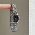 Daisy Dial Bracelet Watch - Silver Strap Black Dial Oval Roman [87K0OK0Y]