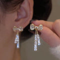Macee Gold Zircon Bow Earrings [DN01QLIR]